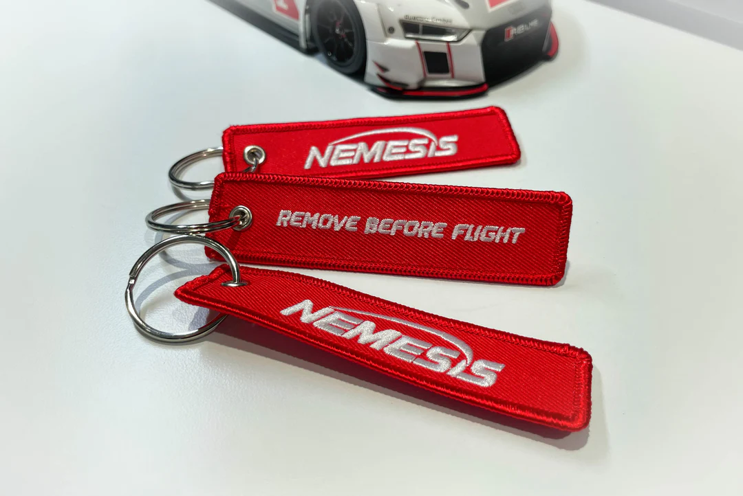 Nemesis Remove Before Flight Keychain